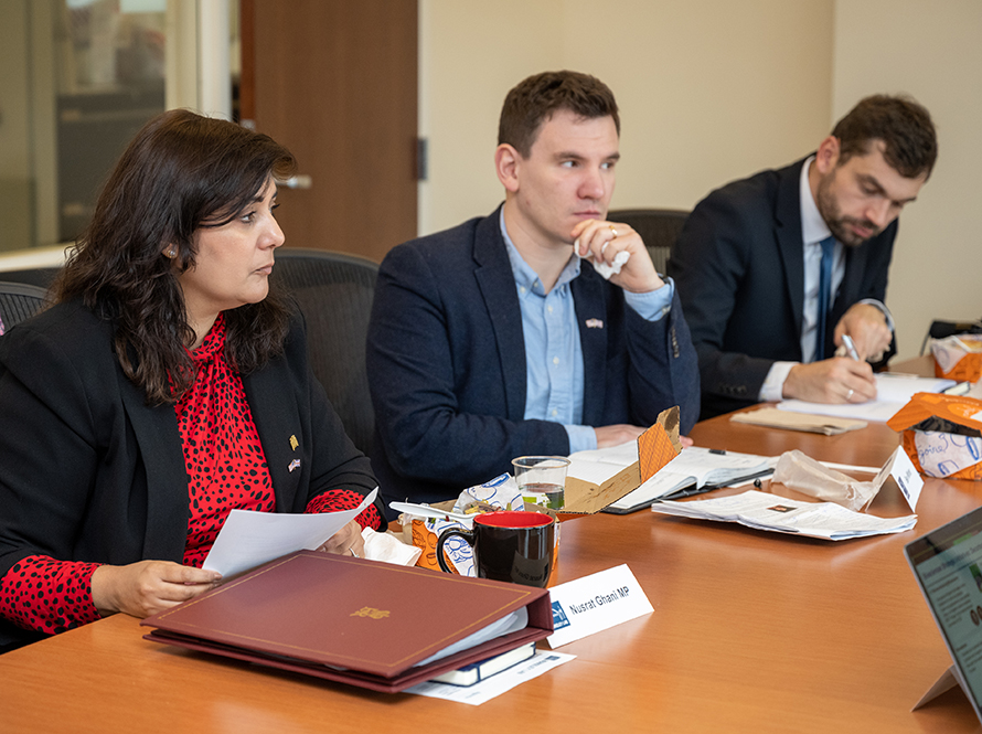 Three people at a conference table