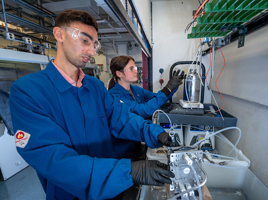 Two researchers in PPE working in lab