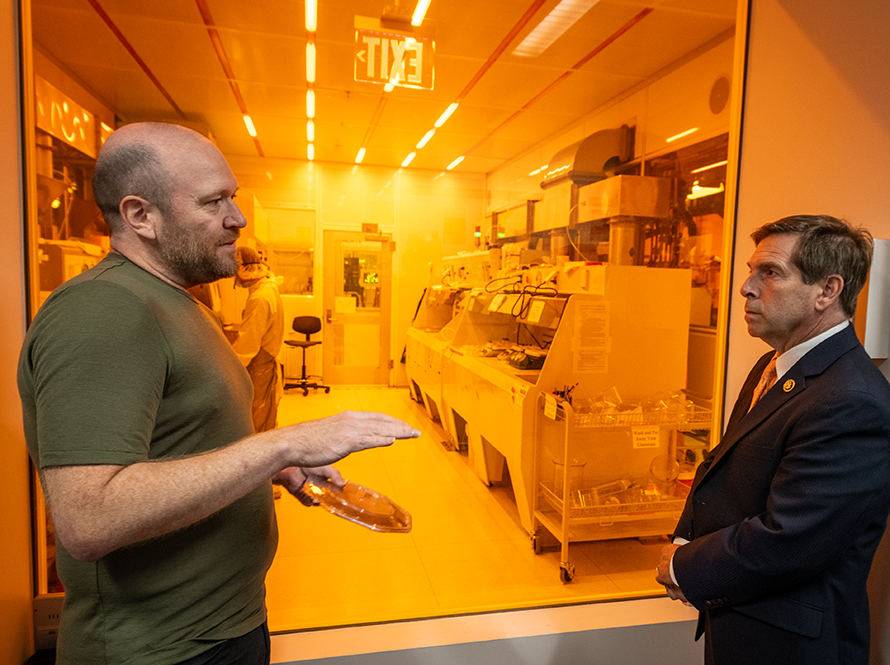 Two people in conversation with lab in background