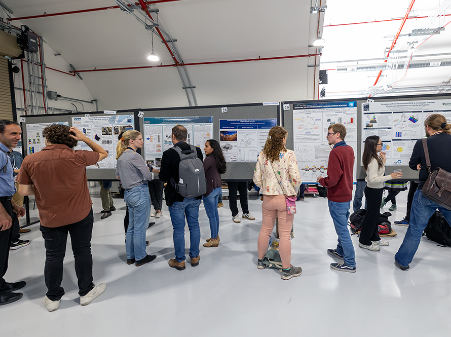 People conversing in front of various presentation boards