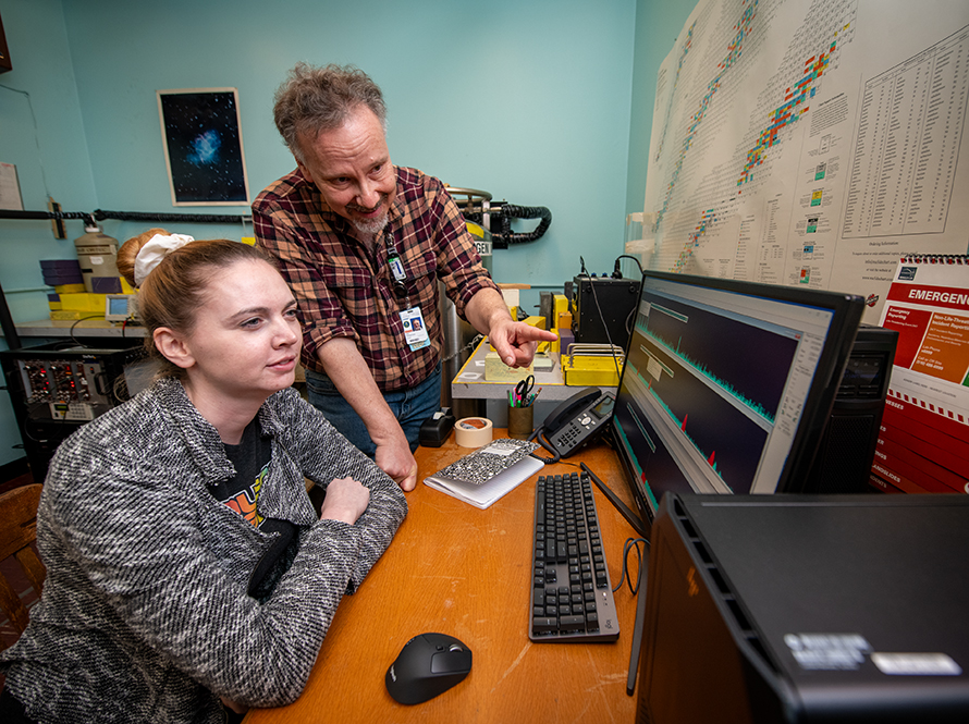 Two people looking at computer monitor